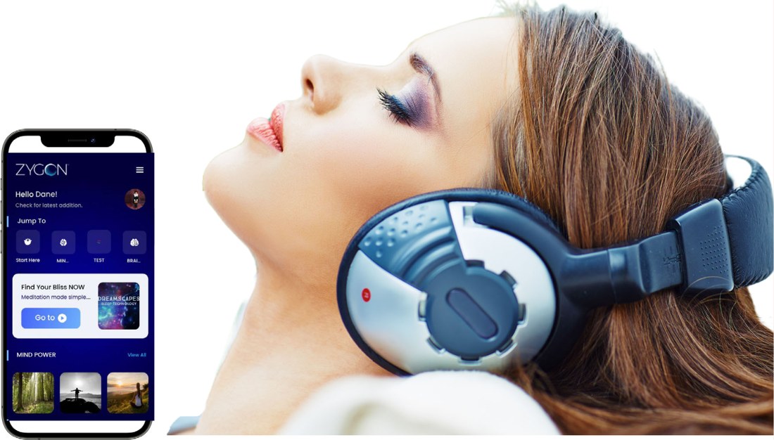 The Zygon Mind Power app open on a phone beside a listener wearing headphones.